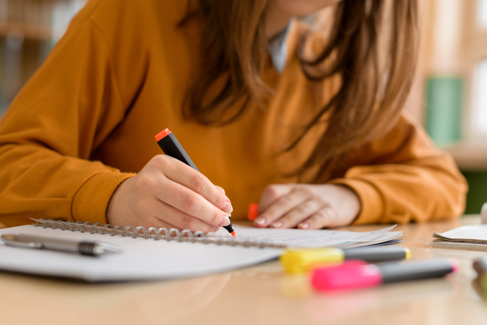 female student highlighting notes