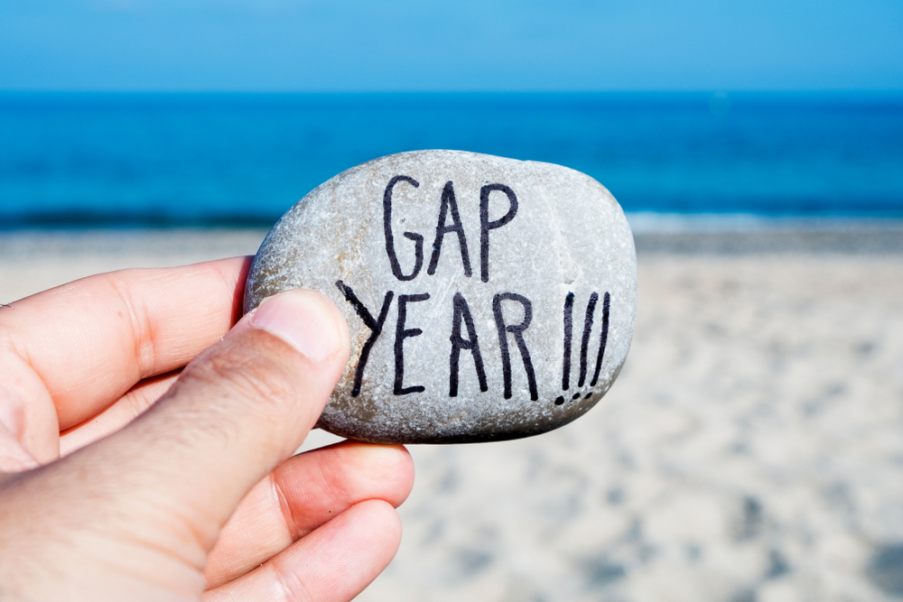 gap year written on stone with beach backdrop