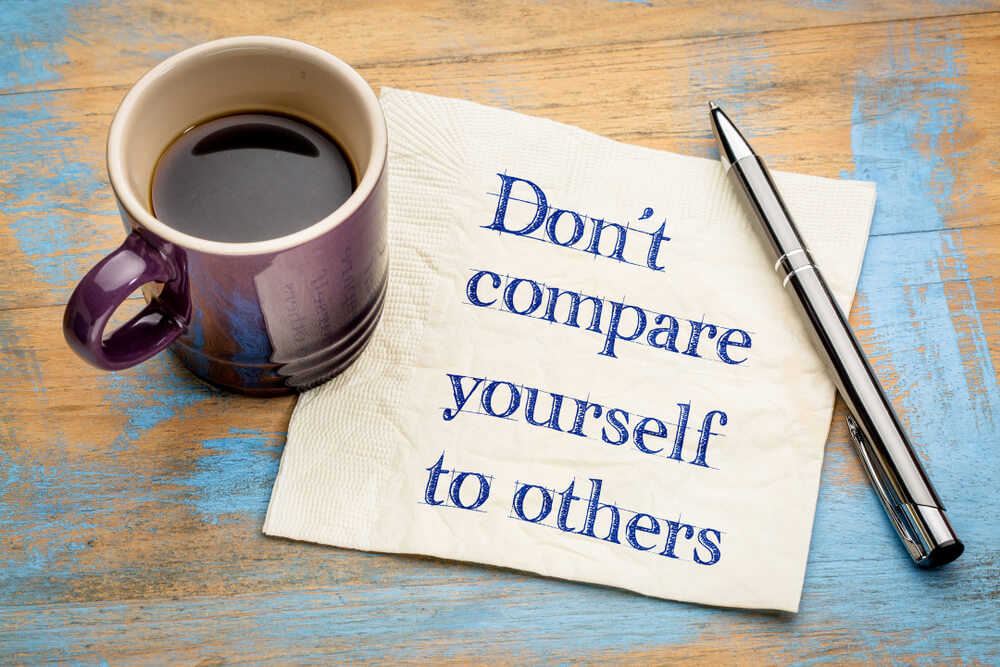 handwritten don't compare yourself message on napkin