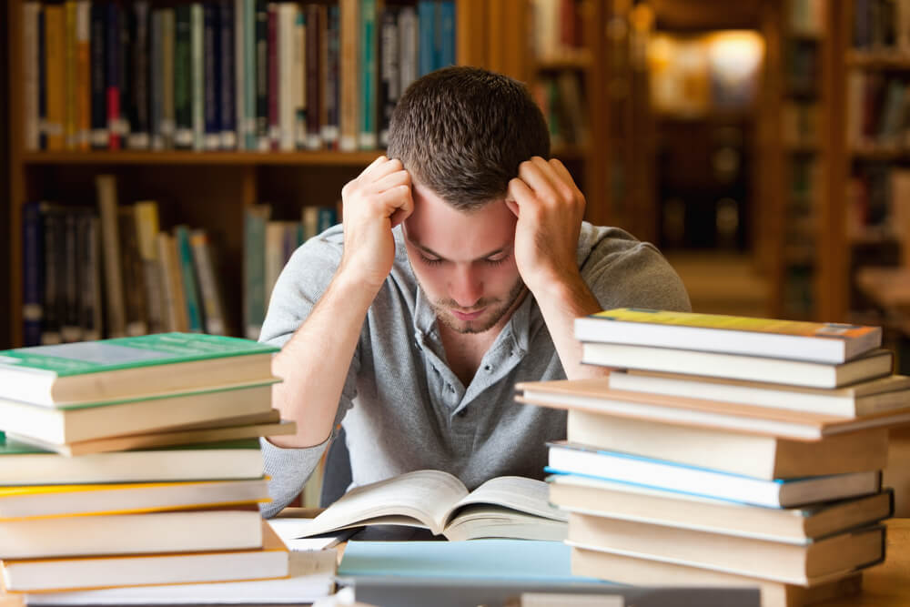 stressed student reading in library