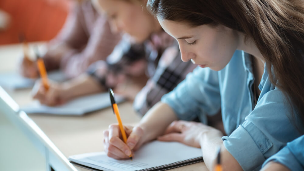 students writing in notebooks