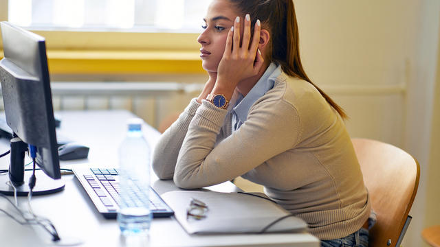 A young woman experiencing difficulties with the online LSAT exam