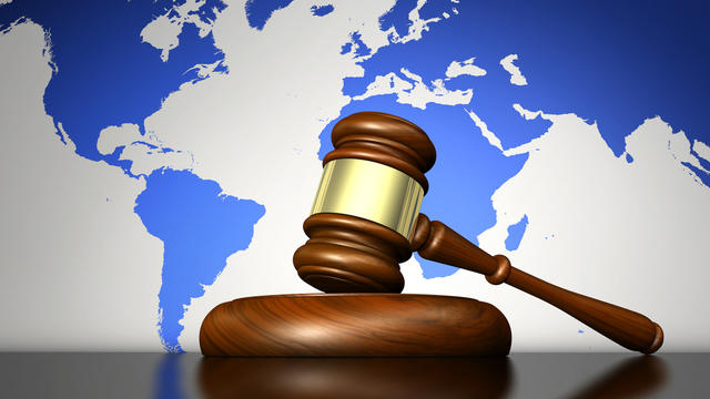 Gavel in front of a world map
