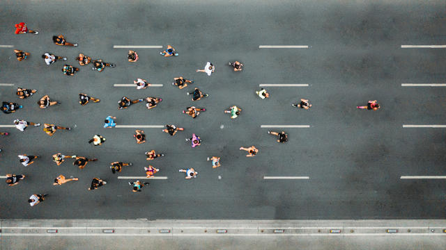 people running a marathon shot from above
