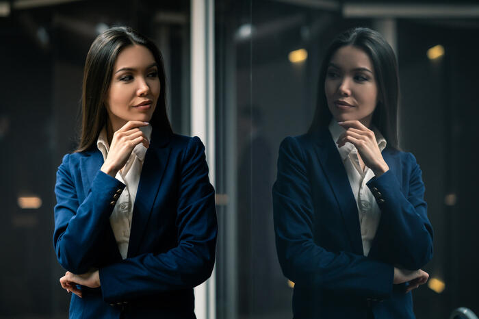 Woman looking at her reflection and reasoning
