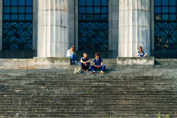 Students studying on steps of law school building