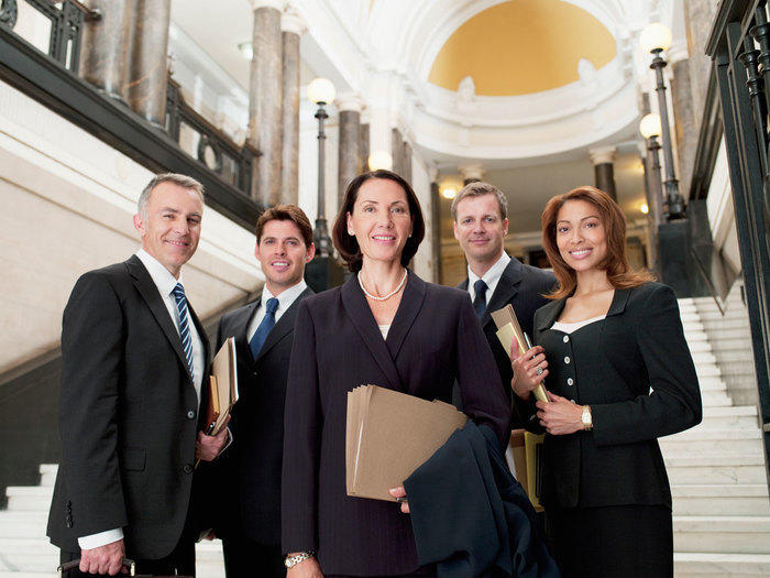 A group of lawyers standing on courthouse stairs